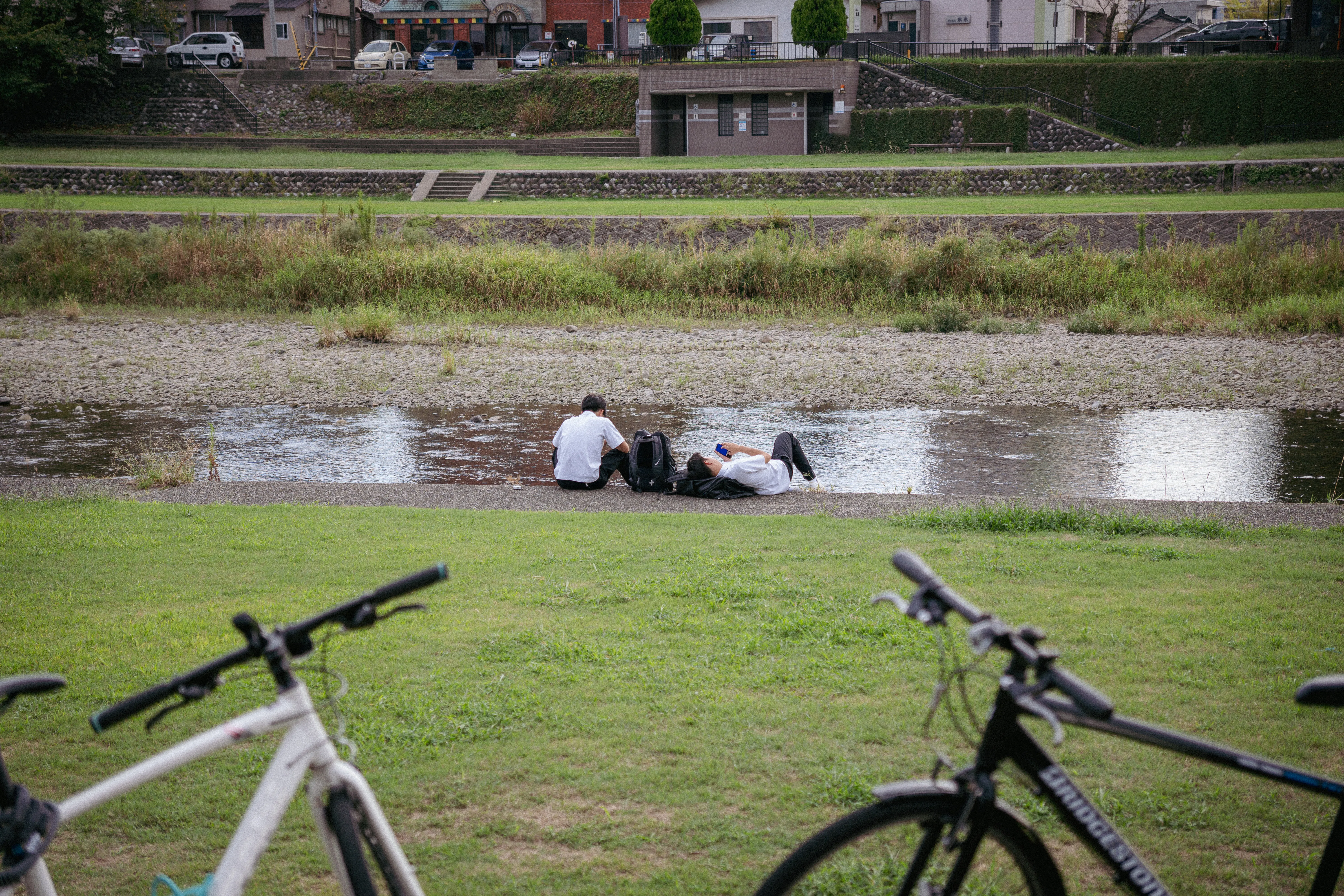 Students lying by the river