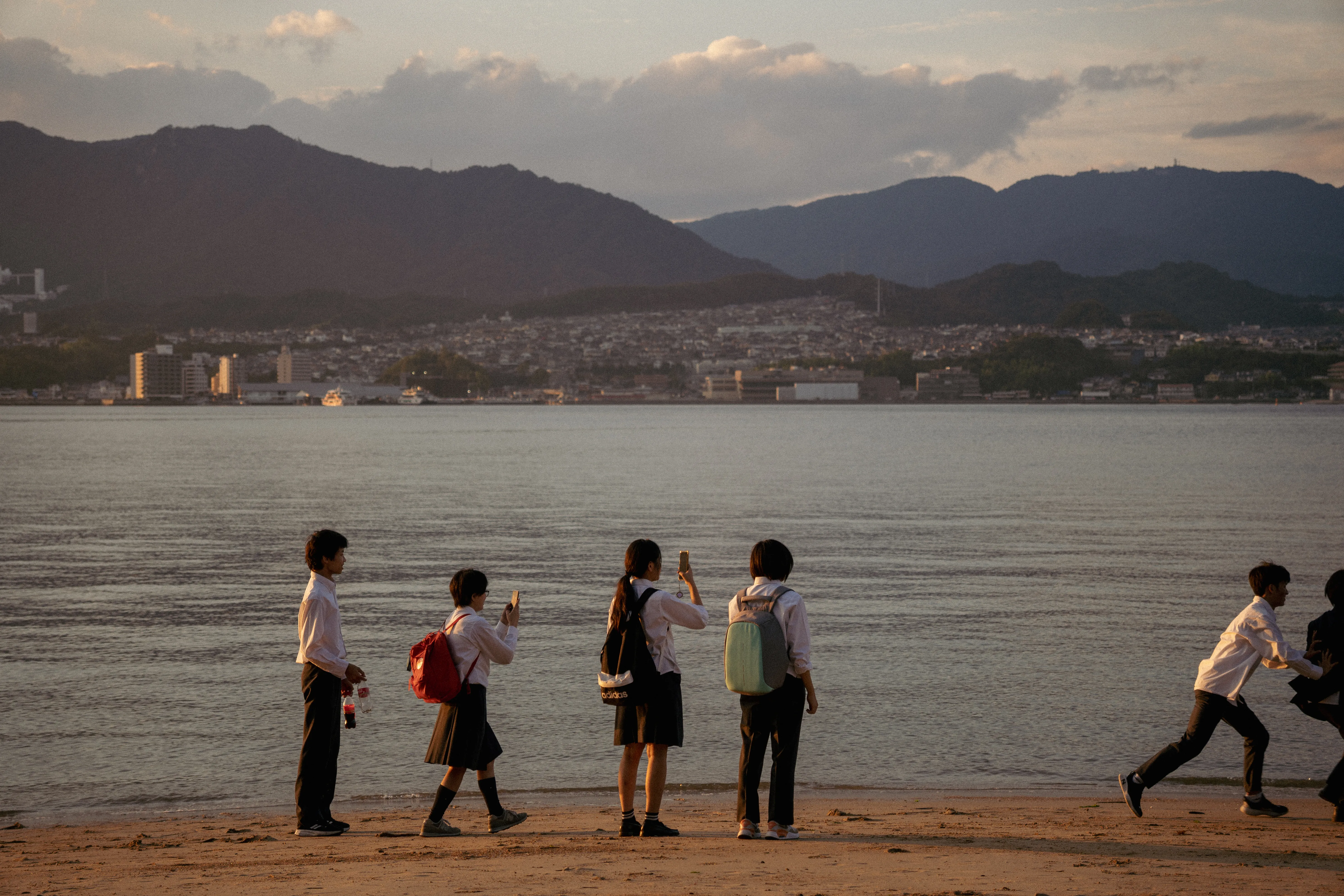 Students on a beach at sunset